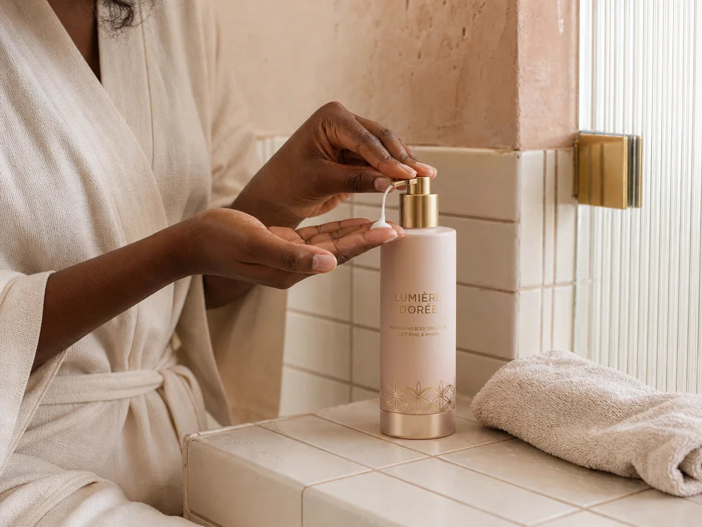 Freeze one physically readable after-shower body-care action in a 4:3 editorial photograph: a Black